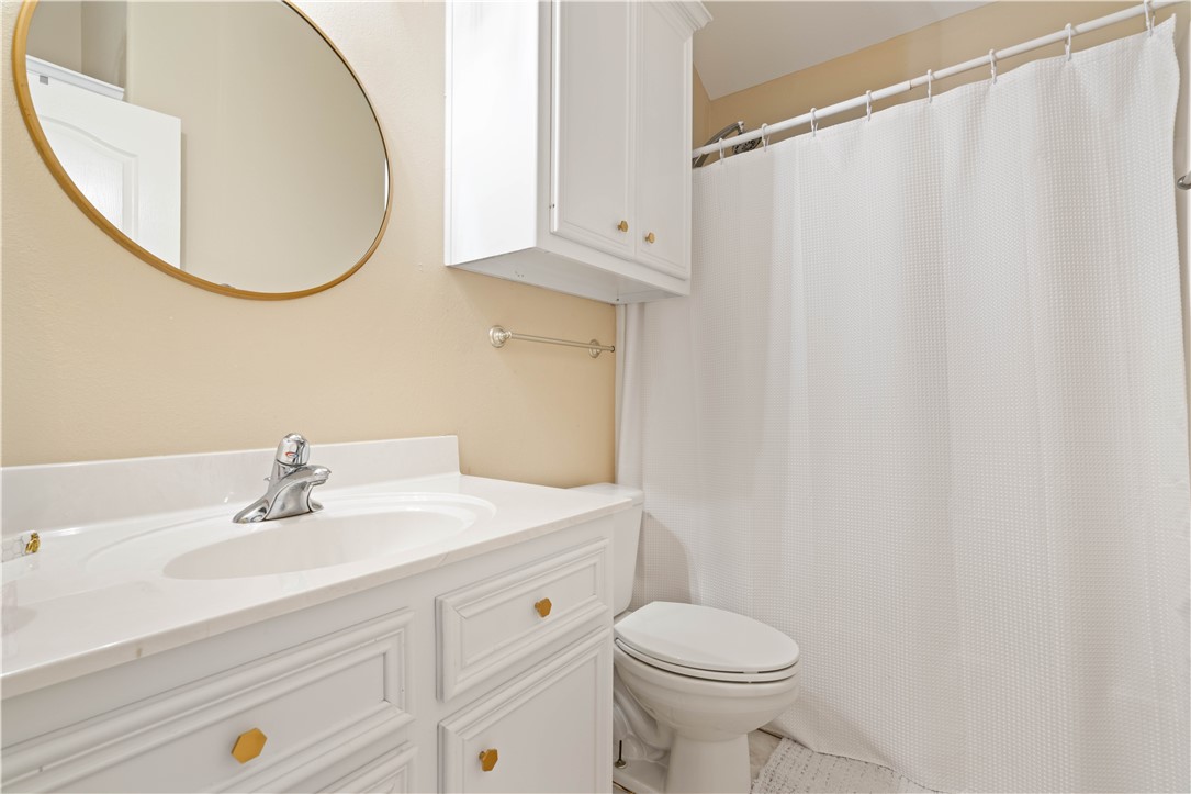 2601 Wool Drive Corpus Christi, TX 78414 - Photo 15 of 25 a bathroom with a sink a toilet and a mirror