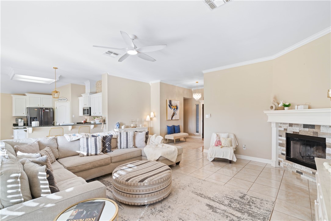 2601 Wool Drive Corpus Christi, TX 78414 - Photo 5 of 25 a living room with furniture a fireplace and a chandelier