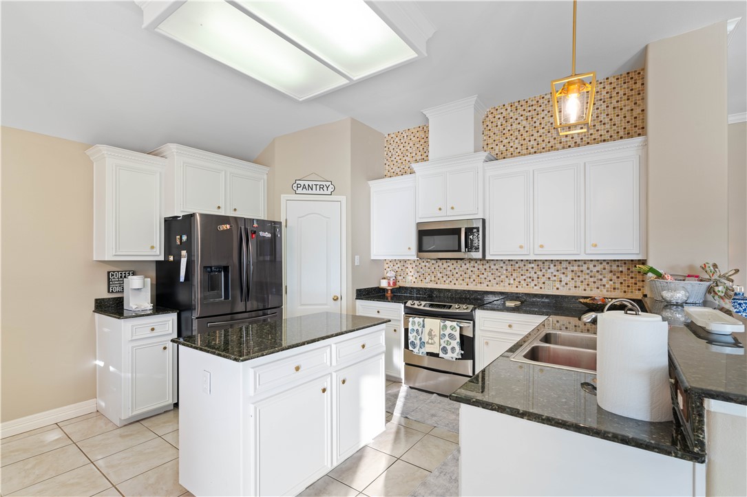 2601 Wool Drive Corpus Christi, TX 78414 - Photo 6 of 25 a kitchen with stainless steel appliances granite countertop a stove refrigerator and sink