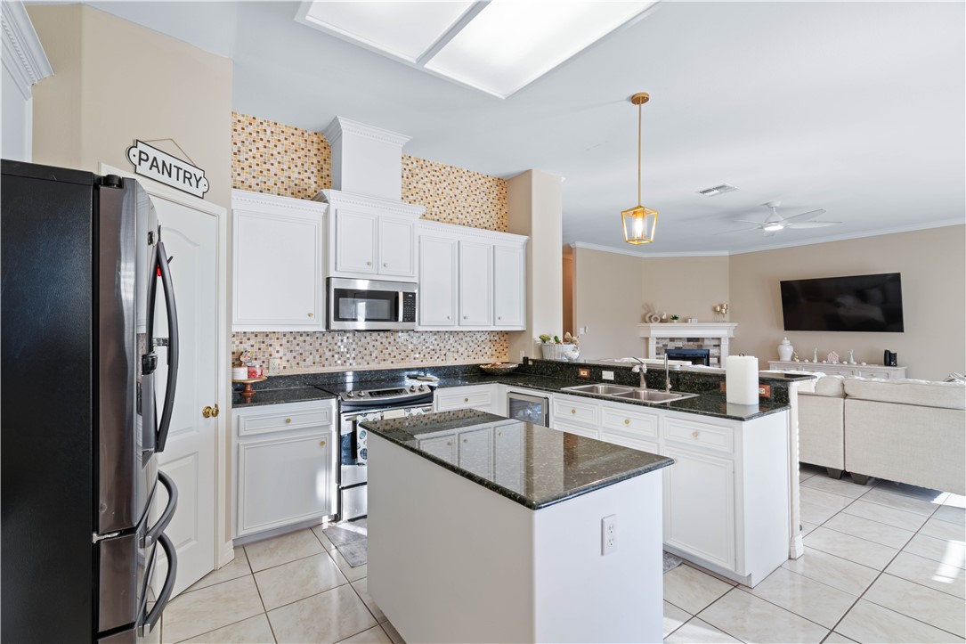 2601 Wool Drive Corpus Christi, TX 78414 - Photo 8 of 25 a kitchen with white cabinets and stainless steel appliances
