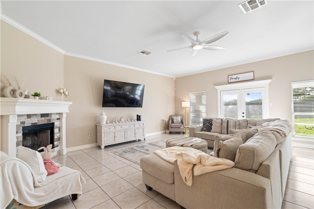 2601 Wool Drive Corpus Christi, TX 78414 - Photo 9 of 25 a living room with furniture a fireplace and a flat screen tv