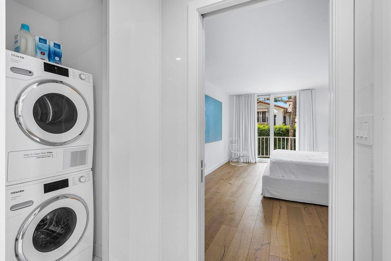 100 Worth Avenue, Unit 220 Palm Beach, FL 33480 - Photo 12 of 22 a view of a bedroom with washer and dryer