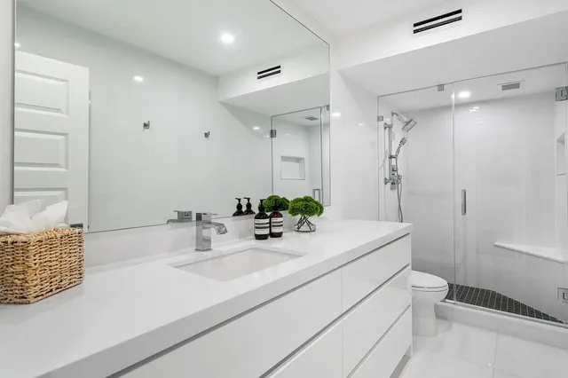 a bathroom with a sink double vanity and a toilet