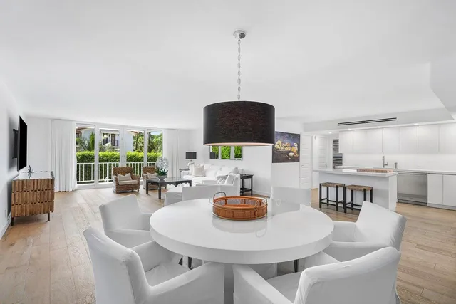 a living room with furniture a window and dining table