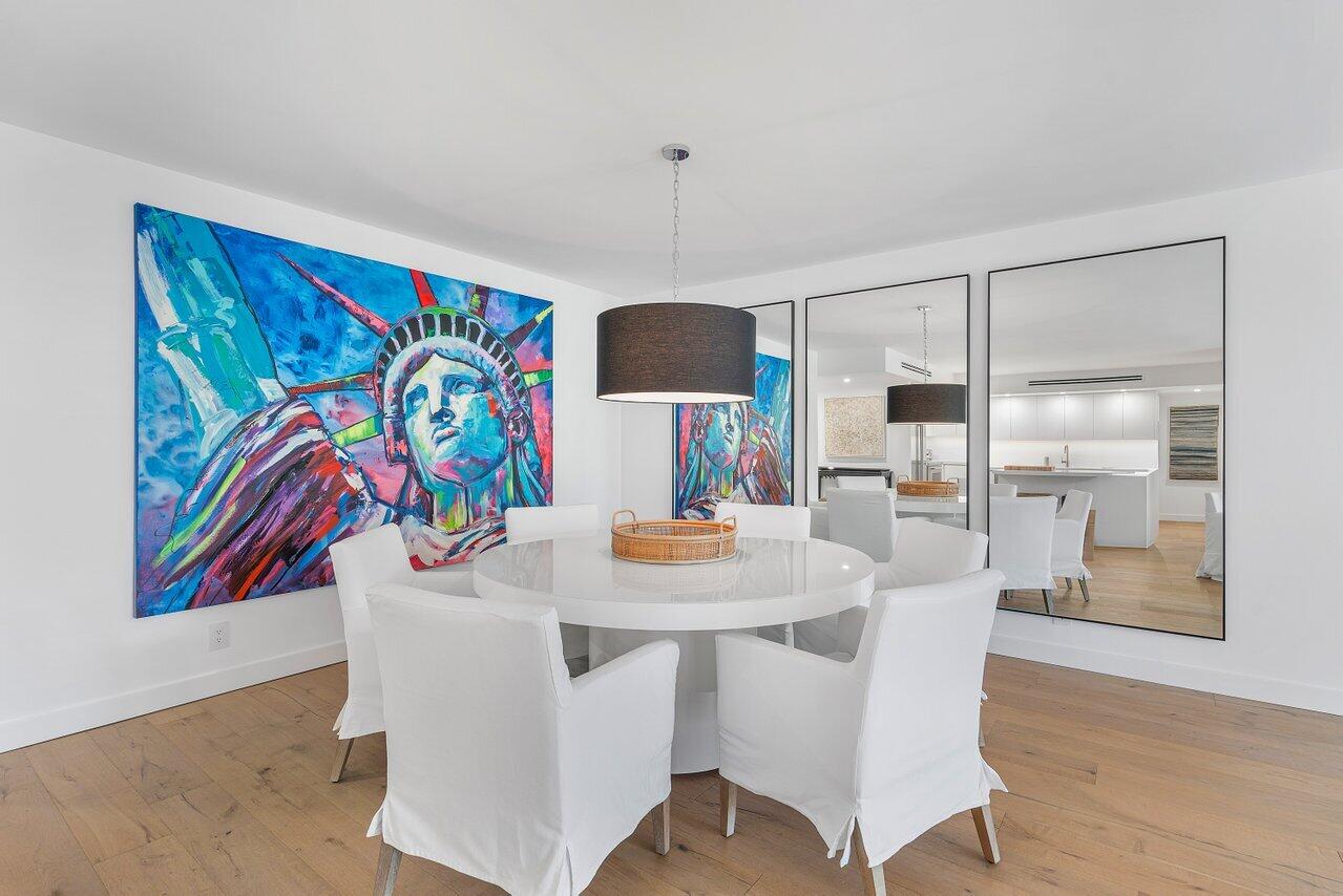 100 Worth Avenue, Unit 220 Palm Beach, FL 33480 - Photo 5 of 22 a view of a dining room with furniture and wooden floor