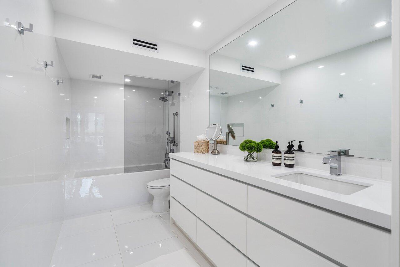 100 Worth Avenue, Unit 220 Palm Beach, FL 33480 - Photo 10 of 22 a bathroom with a double vanity sink toilet and shower
