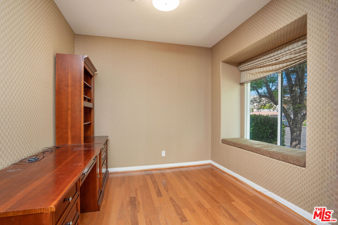 1128 West Duarte Road, Unit A Arcadia, CA 91007 - Photo 7 of 28 a view of an empty room with wooden floor and a window