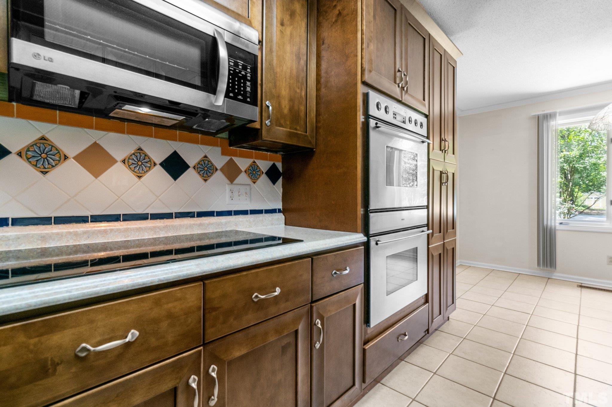 7068 Oak Road Sanford, NC 27332 - Photo 12 of 34 a kitchen with stainless steel appliances granite countertop a stove and a microwave