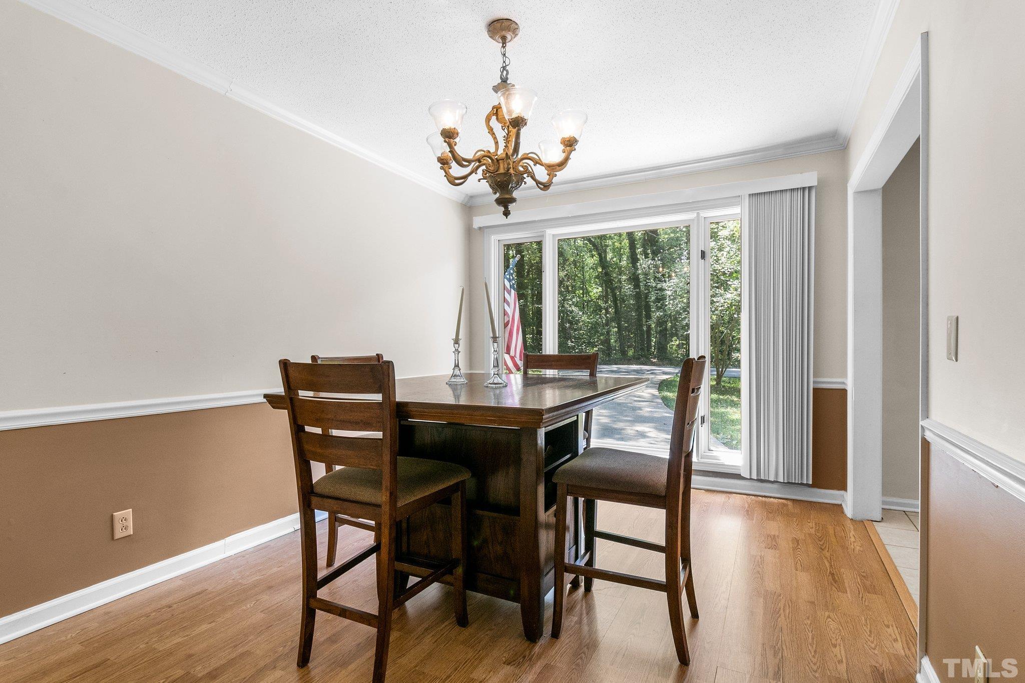 7068 Oak Road Sanford, NC 27332 - Photo 13 of 34 a view of a dining room with furniture window and wooden floor