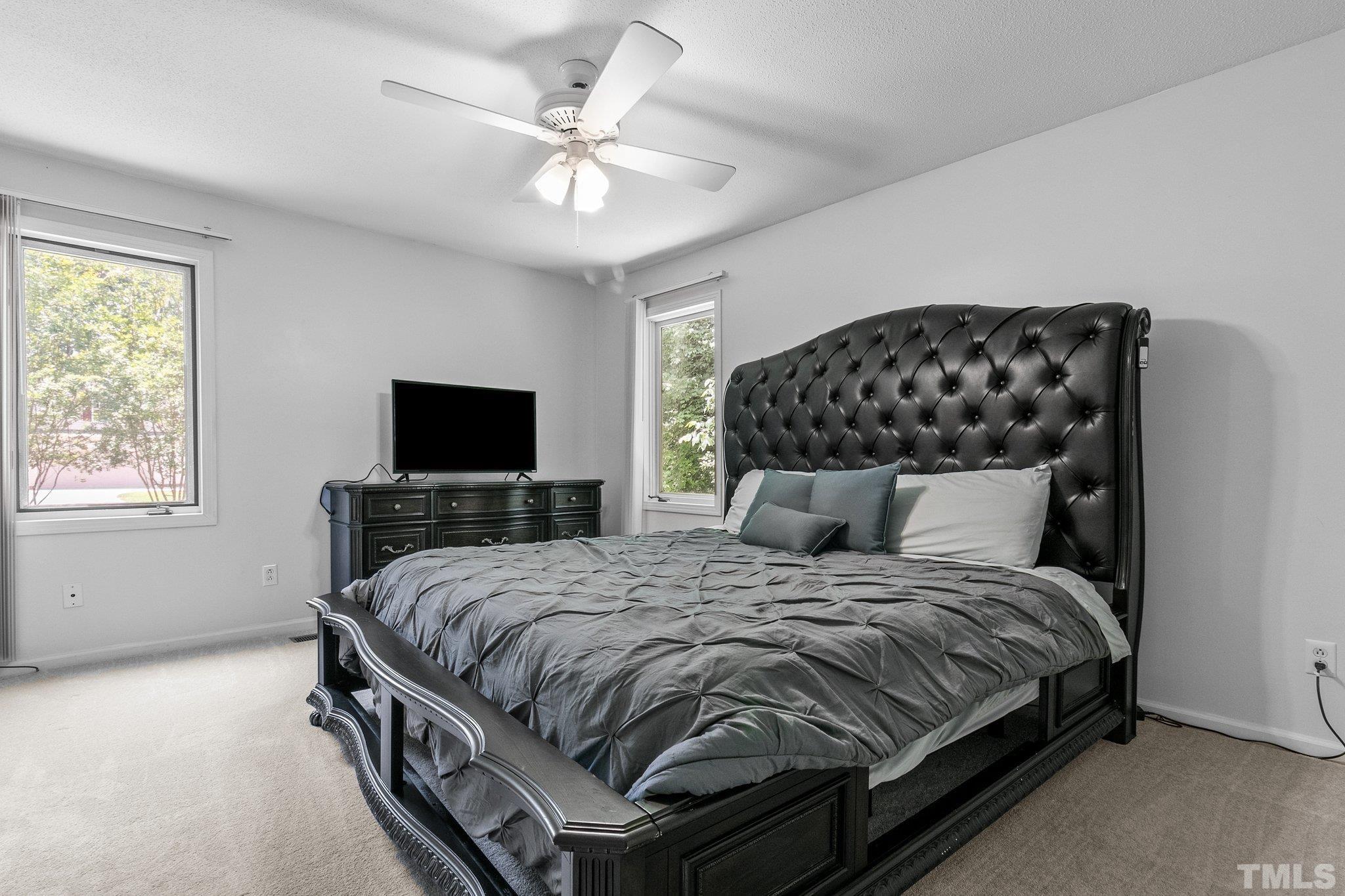 7068 Oak Road Sanford, NC 27332 - Photo 19 of 34 a bedroom with a bed and a flat screen tv