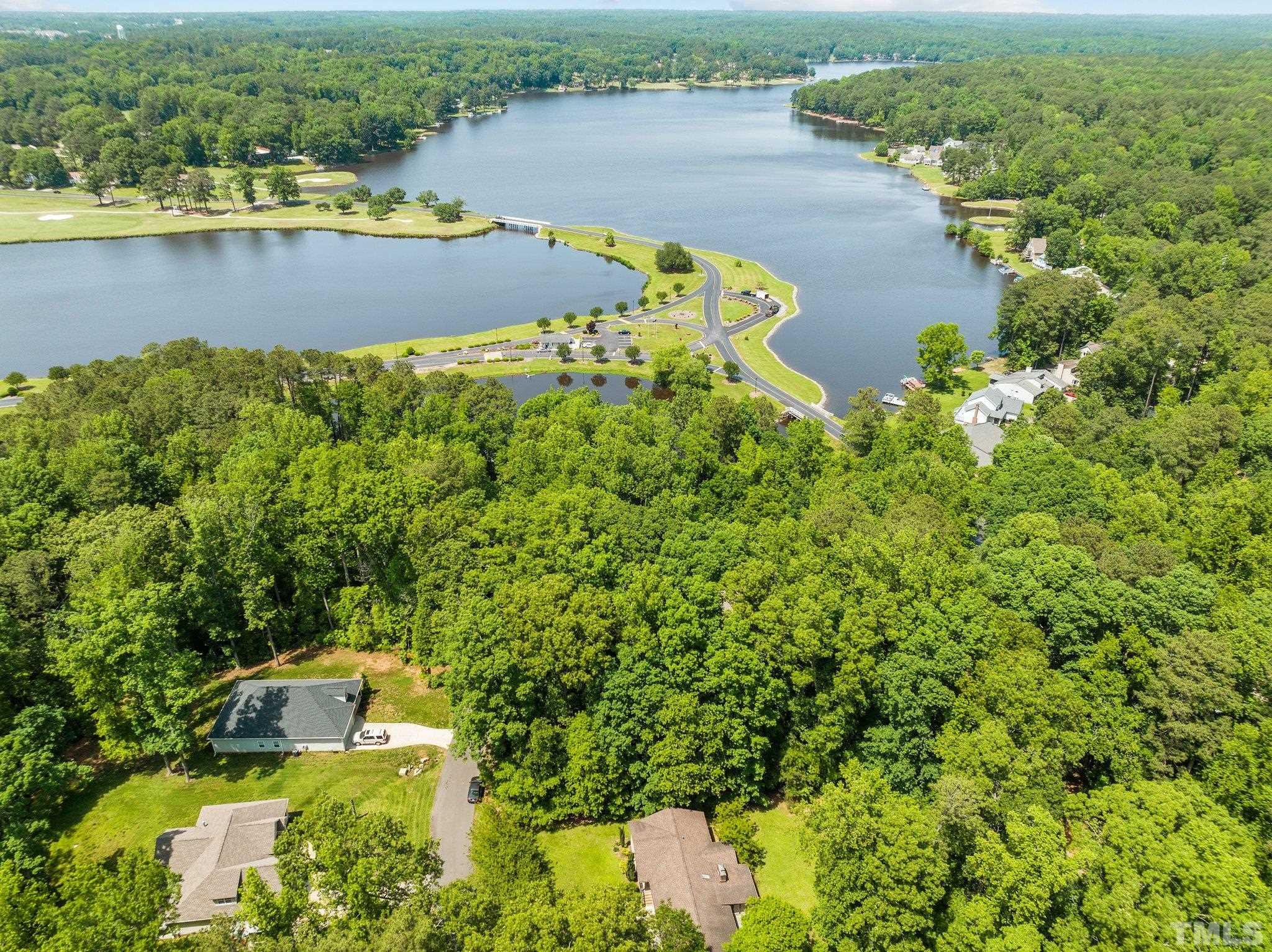 7068 Oak Road Sanford, NC 27332 - Photo 31 of 34 an aerial view of residential houses with outdoor space and lake view