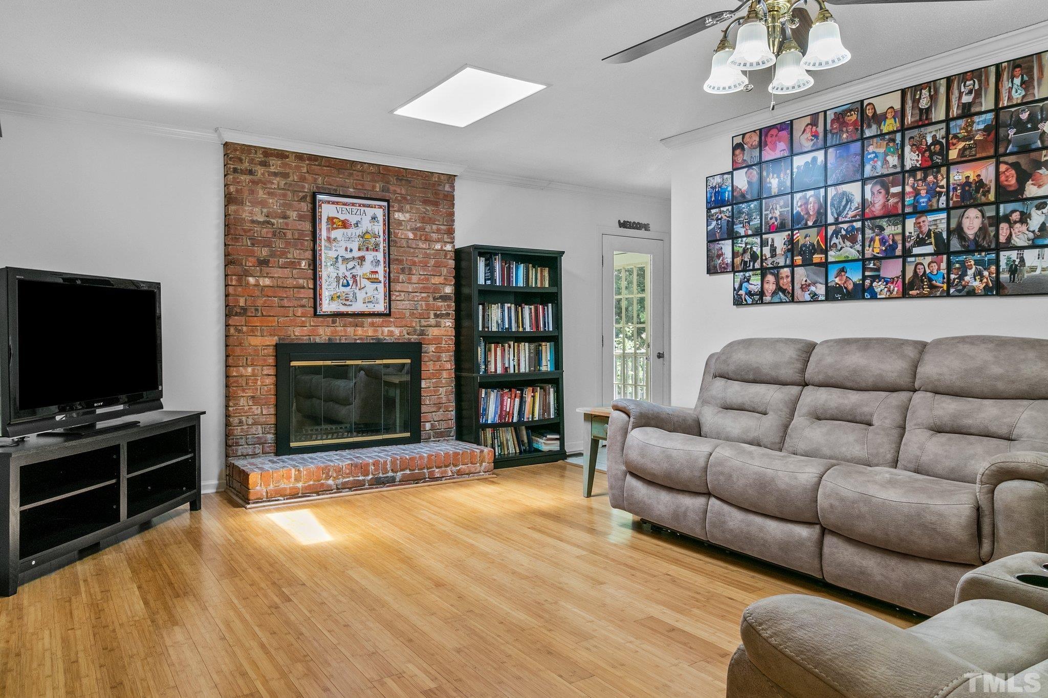7068 Oak Road Sanford, NC 27332 - Photo 7 of 34 a living room with fireplace furniture and a flat screen tv