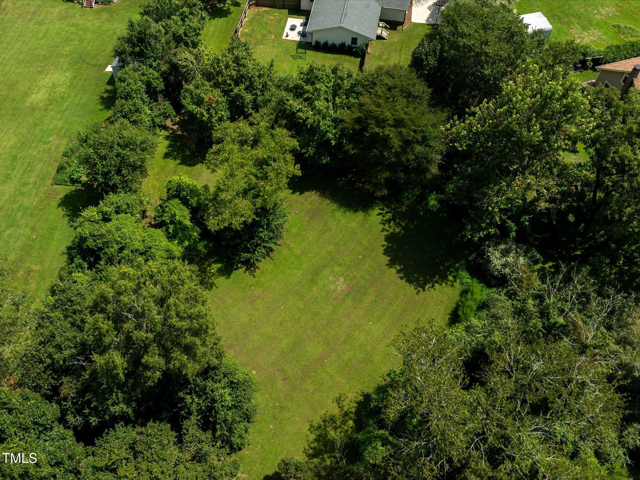 3320 High Gate Road Raleigh, NC 27603 - Photo 34 of 40 The lot goes well beyond the fence extending the flat continuous treed area behind the house giving the property a very private feel