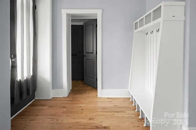 a view of a hallway with wooden floor