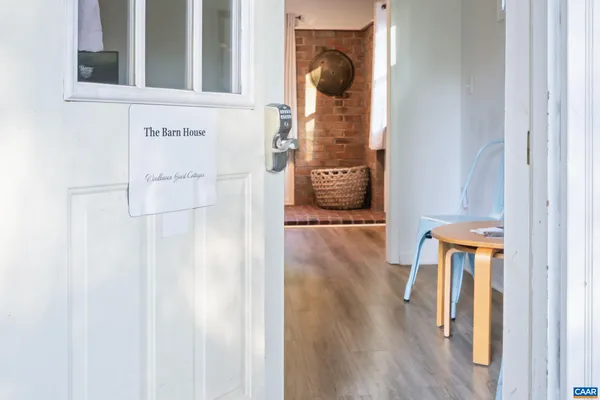 a view of entryway and hall with wooden floor