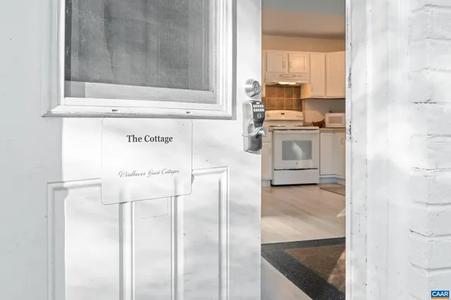 a kitchen with white cabinets and white appliances