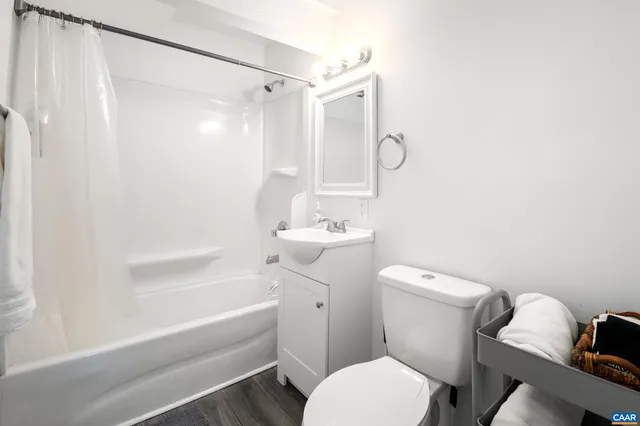 a white toilet sitting next to a bath tub