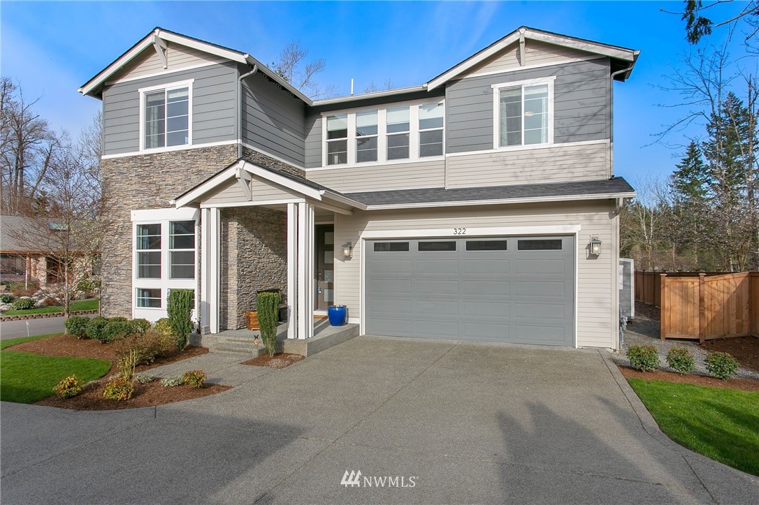 322 Graham Avenue Southeast Renton, WA 98059 - Photo 2 of 39 a front view of a house with a yard and garage
