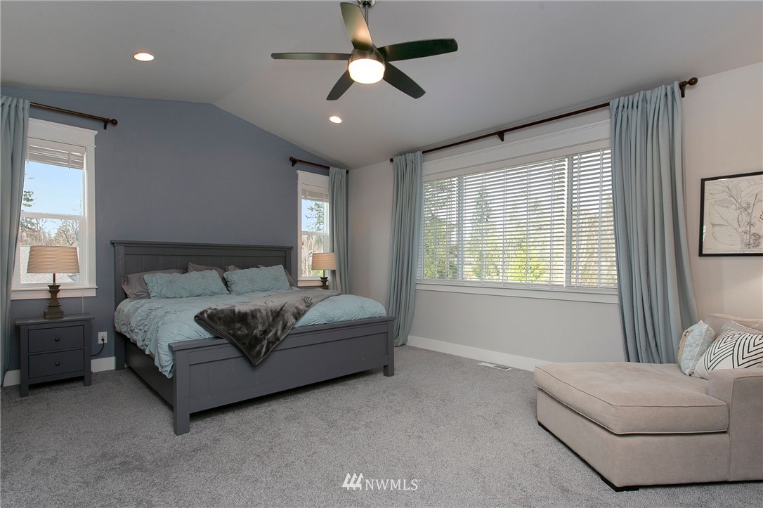 322 Graham Avenue Southeast Renton, WA 98059 - Photo 17 of 39 a spacious bedroom with a bed couch and window