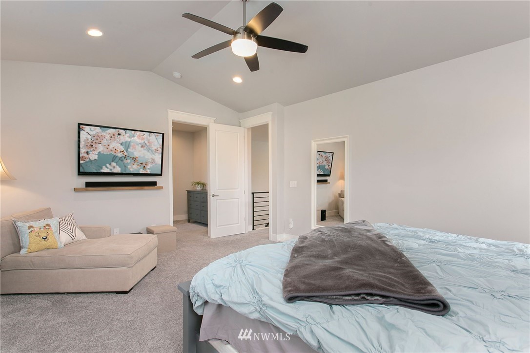 322 Graham Avenue Southeast Renton, WA 98059 - Photo 18 of 39 a bedroom with a large bed and a chandelier