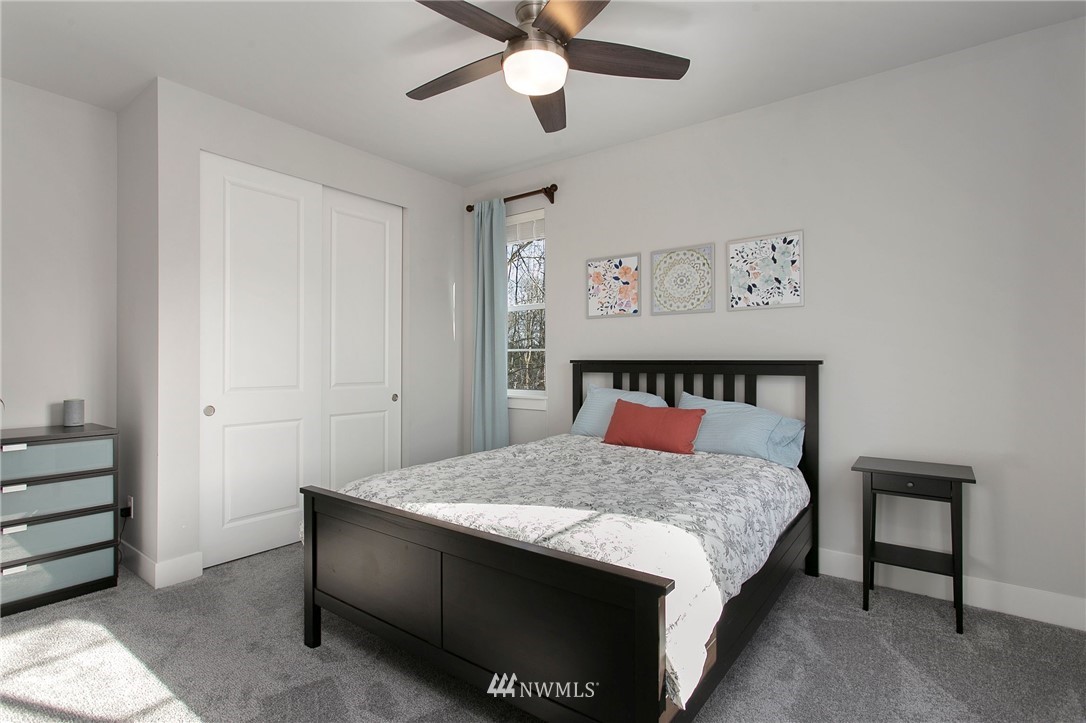 322 Graham Avenue Southeast Renton, WA 98059 - Photo 26 of 39 a bedroom with a bed and a chandelier