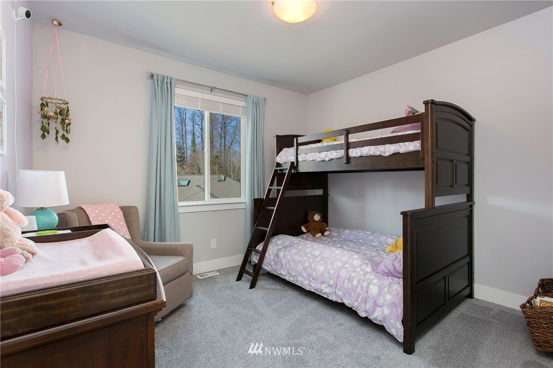 322 Graham Avenue Southeast Renton, WA 98059 - Photo 27 of 39 a bedroom with a bed and a window