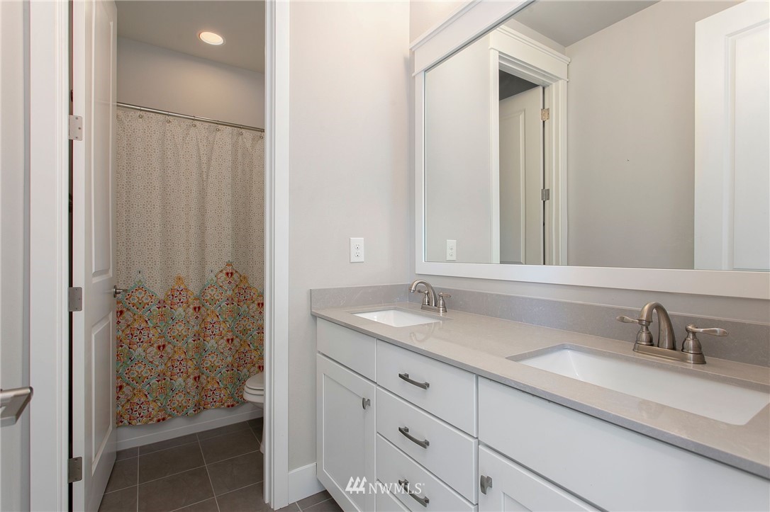 322 Graham Avenue Southeast Renton, WA 98059 - Photo 29 of 39 a bathroom with a granite countertop sink and a mirror