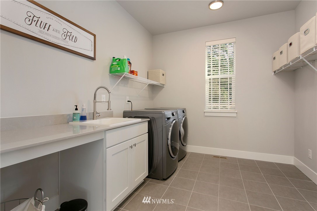 322 Graham Avenue Southeast Renton, WA 98059 - Photo 30 of 39 a utility room with a sink a washer and dryer