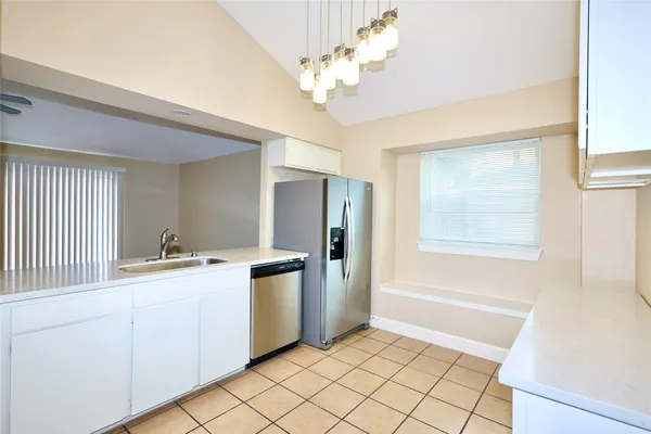 a kitchen with stainless steel appliances granite countertop a refrigerator a sink a stove and island