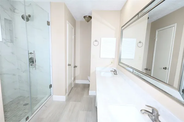 a bathroom with a tub and shower