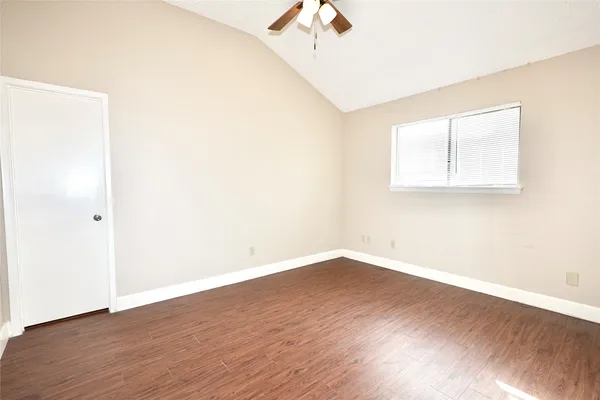 a view of a room with wooden floor and windows