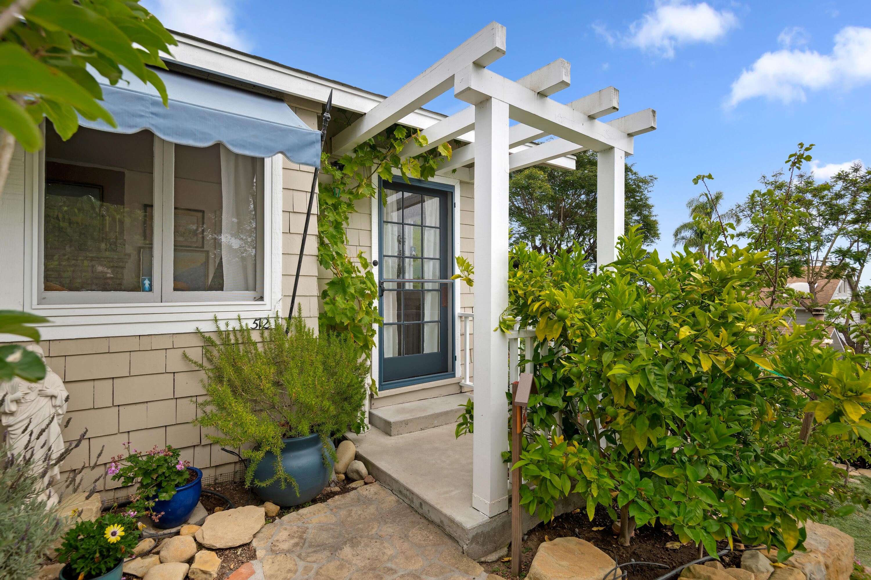 512 East Islay Street Santa Barbara, CA 93101 - Photo 3 of 25 a view of brick house with potted plants