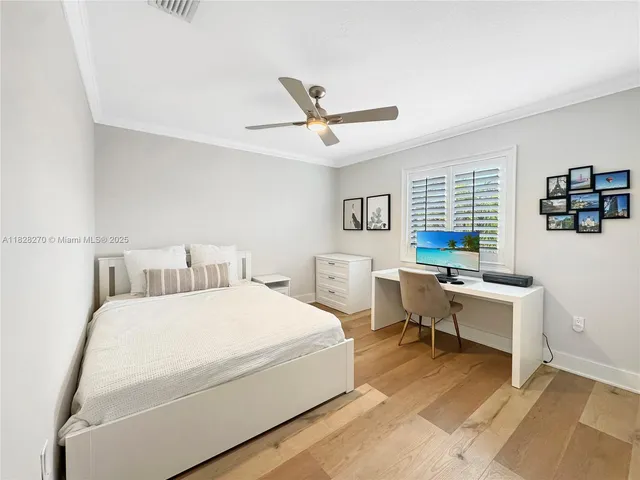 a bedroom with a bed and a desk