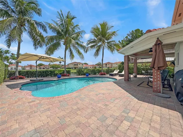 a view of swimming pool with outdoor seating and a patio