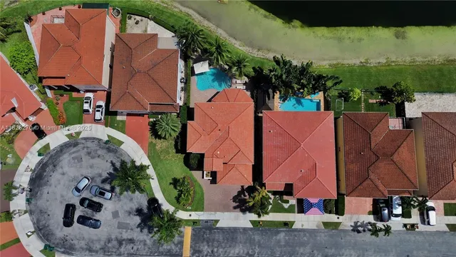 an aerial view of a house with a yard and lake view