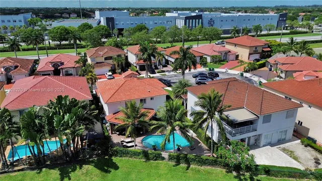 an aerial view of multiple houses with yard