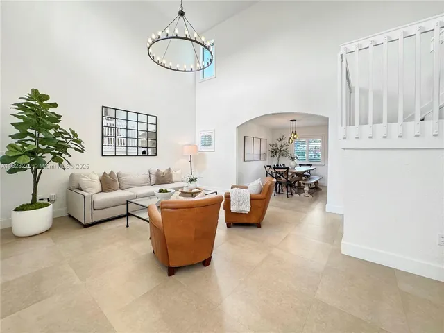 a living room with furniture and chandelier