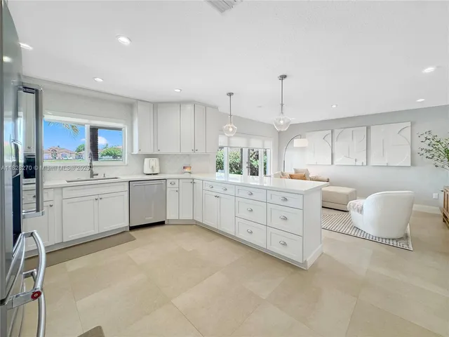 a kitchen with white cabinets and white appliances