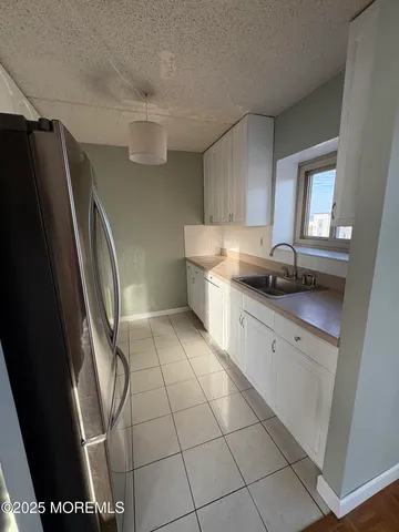 a kitchen with stainless steel appliances a refrigerator sink and cabinets
