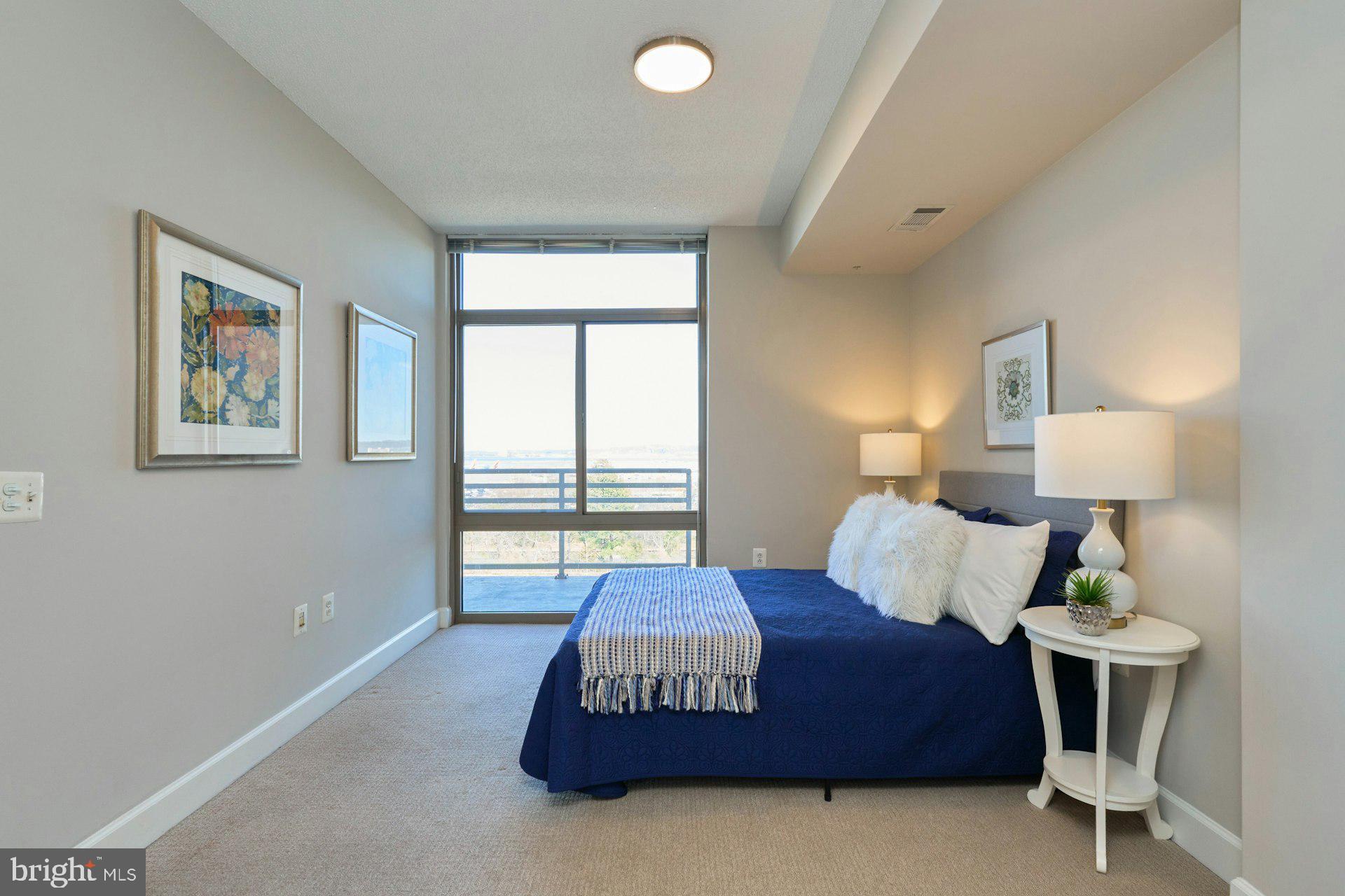 3650 South Glebe Road, Unit 652 Arlington, VA 22202 - Photo 18 of 54 a spacious bedroom with a bed and a lamp