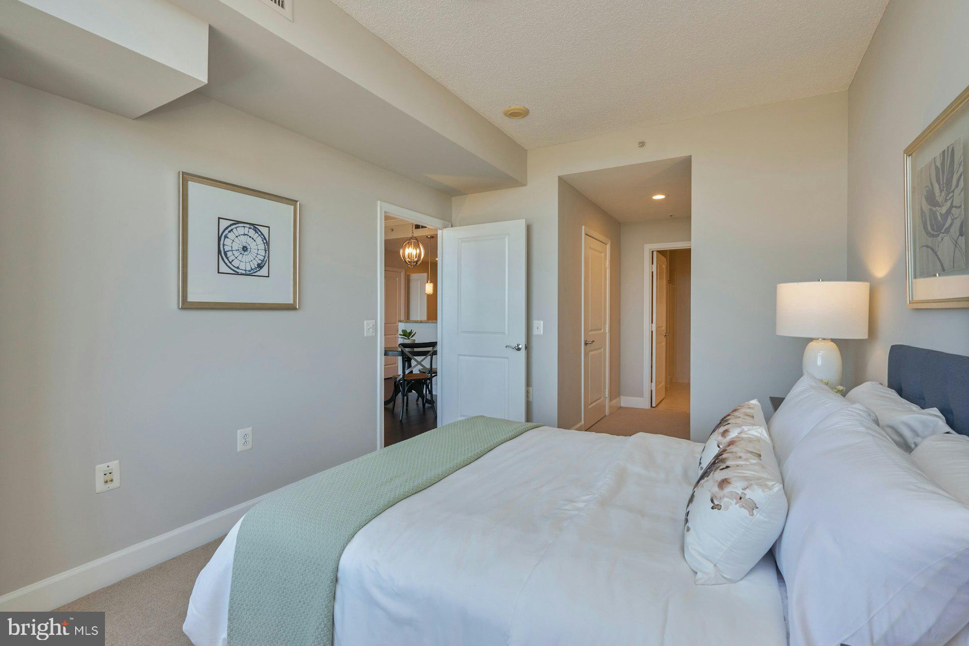 3650 South Glebe Road, Unit 652 Arlington, VA 22202 - Photo 24 of 54 a bedroom with a bed and a painting on the wall
