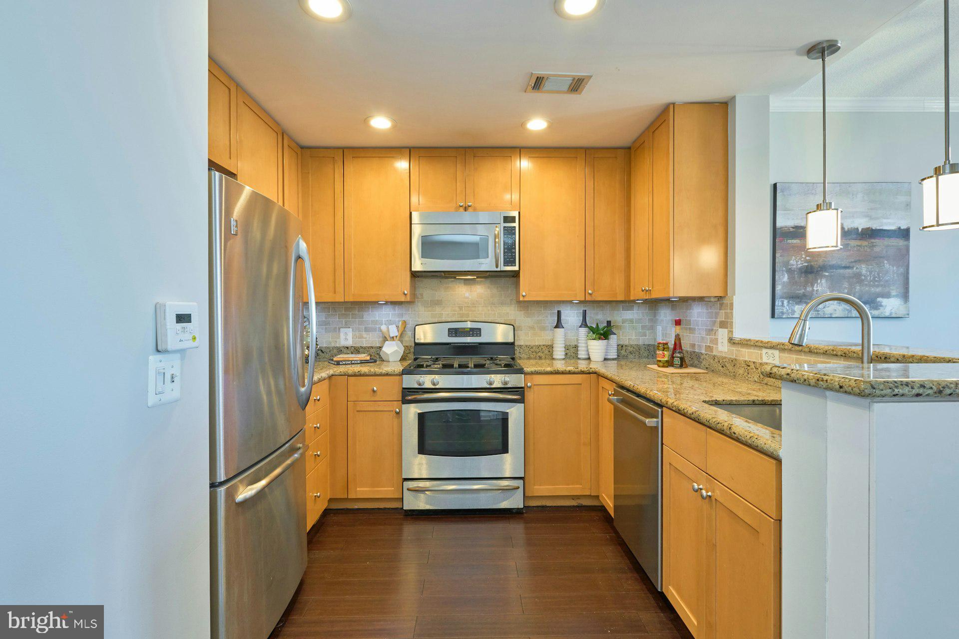 3650 South Glebe Road, Unit 652 Arlington, VA 22202 - Photo 7 of 54 a kitchen with stainless steel appliances granite countertop a sink a stove and a refrigerator