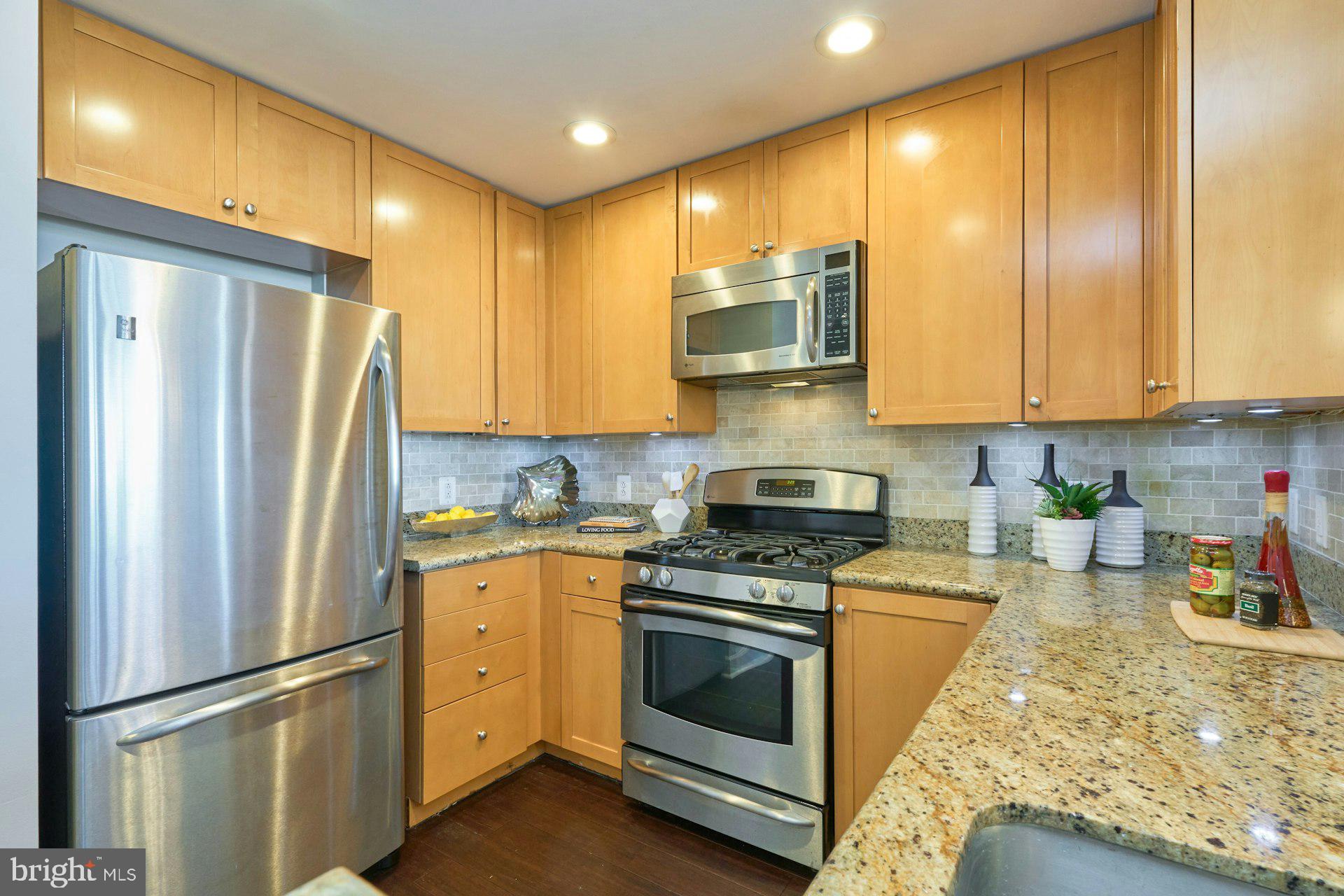 3650 South Glebe Road, Unit 652 Arlington, VA 22202 - Photo 8 of 54 a kitchen with stainless steel appliances granite countertop a refrigerator sink and stove