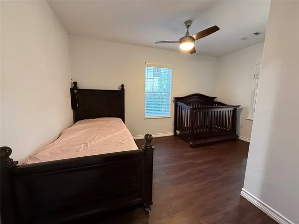 a bed sitting in a room next to a window