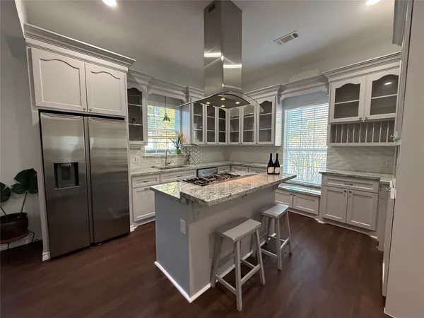 a kitchen with a stove a refrigerator and a stove top oven