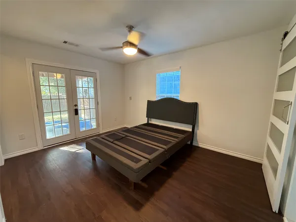 a room with wooden floor and pool table