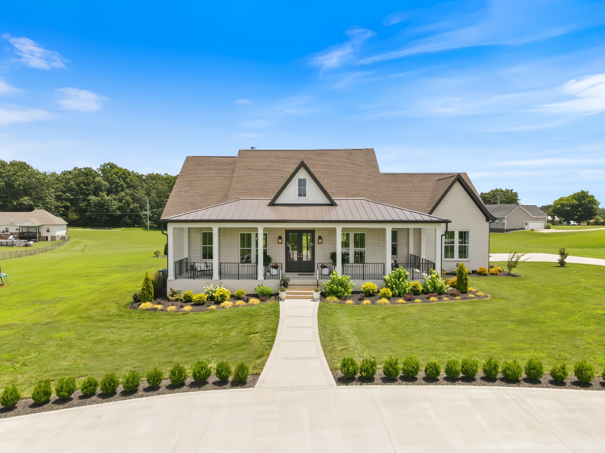 a front view of a house with a garden