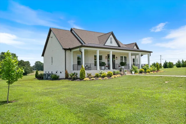 a front view of a house with potted plants
