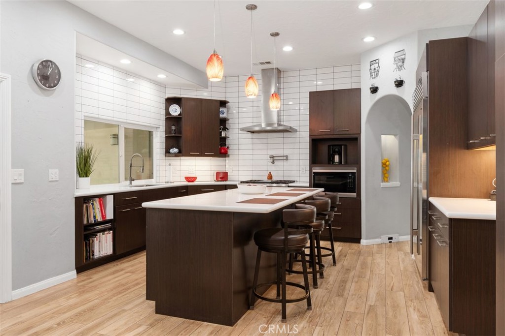 3950 Concordia Lane Fallbrook, CA 92028 - Photo 17 of 51 a kitchen with stainless steel appliances granite countertop a refrigerator a sink dishwasher a stove and a refrigerator with wooden floor