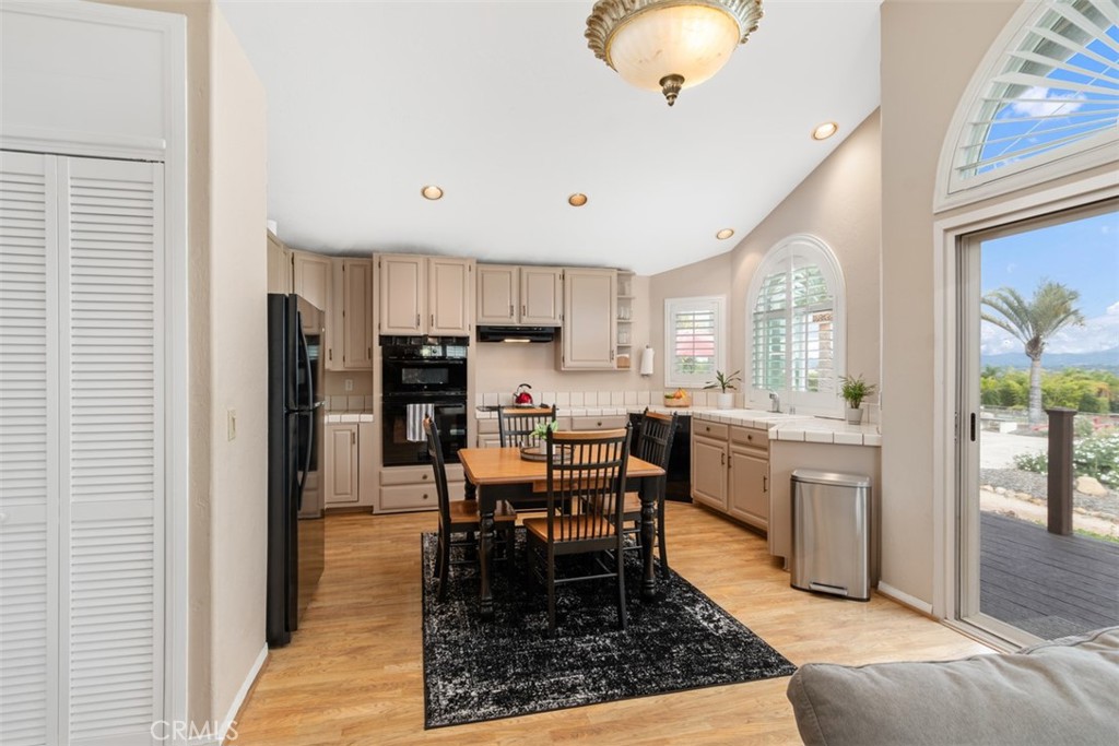 3950 Concordia Lane Fallbrook, CA 92028 - Photo 34 of 51 a kitchen with stainless steel appliances granite countertop dining table chairs and a refrigerator
